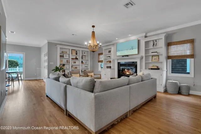 a living room with fireplace furniture and a wooden floor