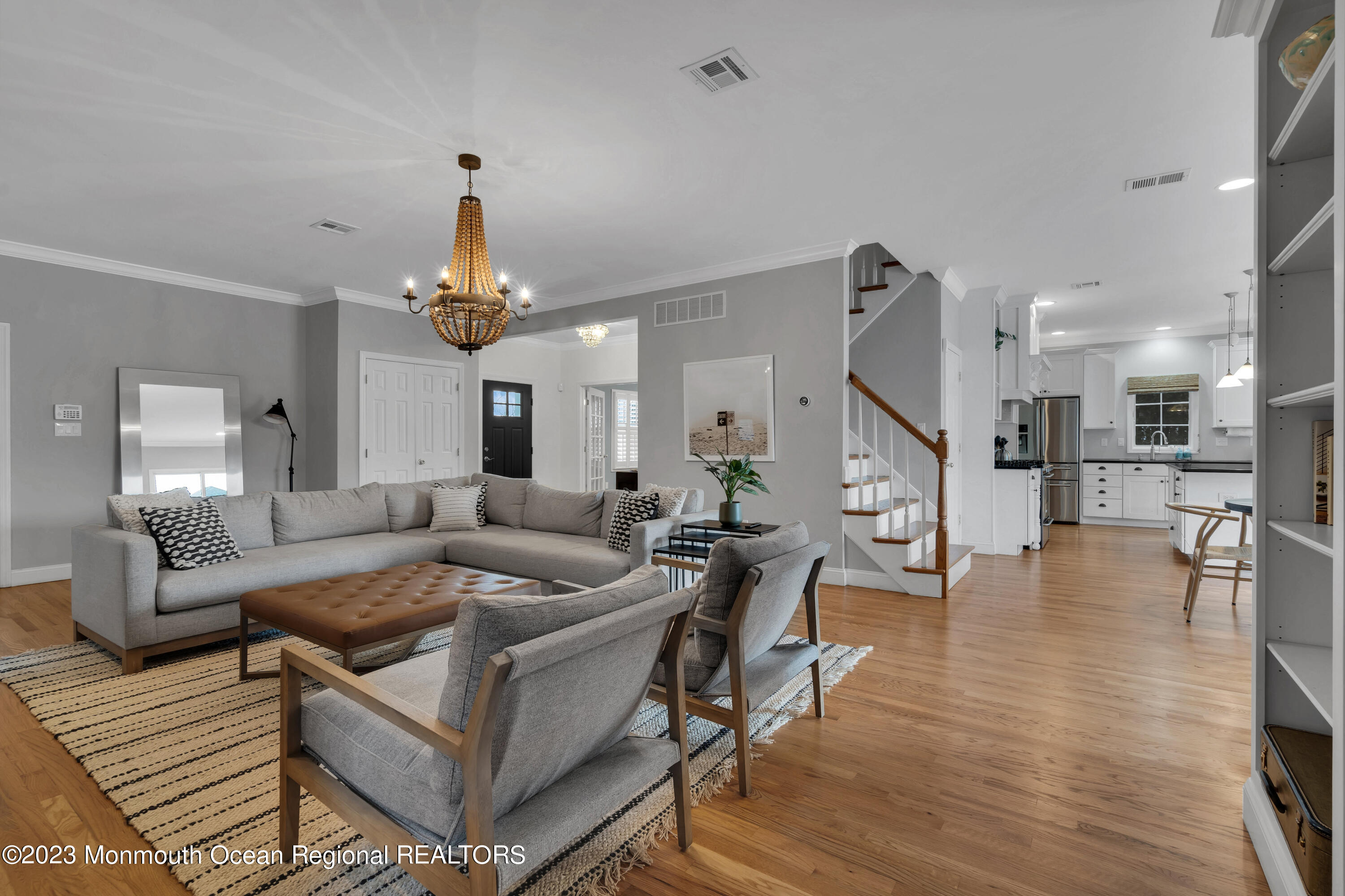 89 Mclean Avenue Manasquan, NJ 08736 - Photo 9 of 38 a living room with furniture and a chandelier