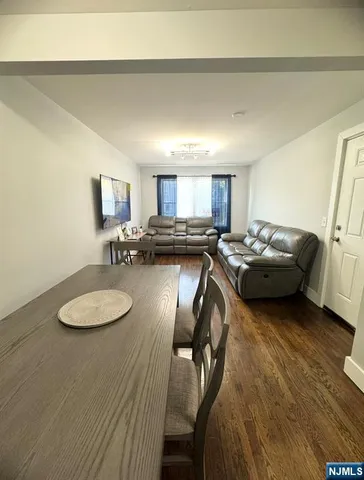 a kitchen with a table chairs refrigerator and microwave