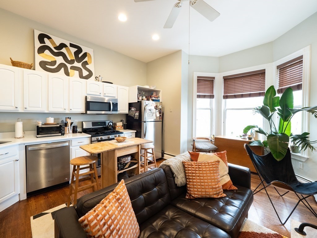 a living room with kitchen island furniture and a window