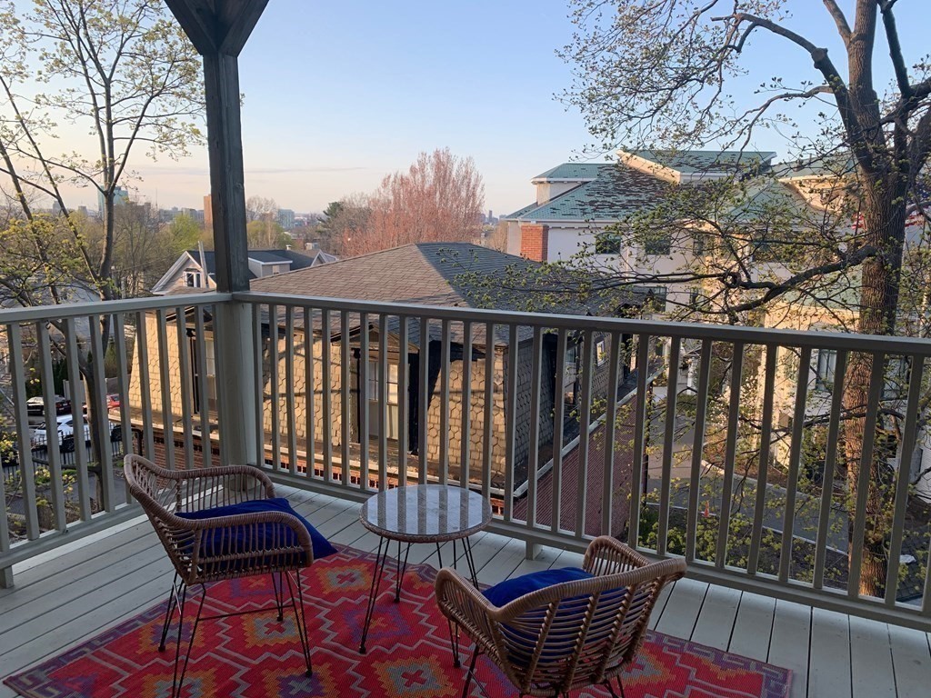 25 Fort Avenue, Unit 2 Boston, MA 02119 - Photo 12 of 12 a view of a roof deck with wooden fence and wooden floor
