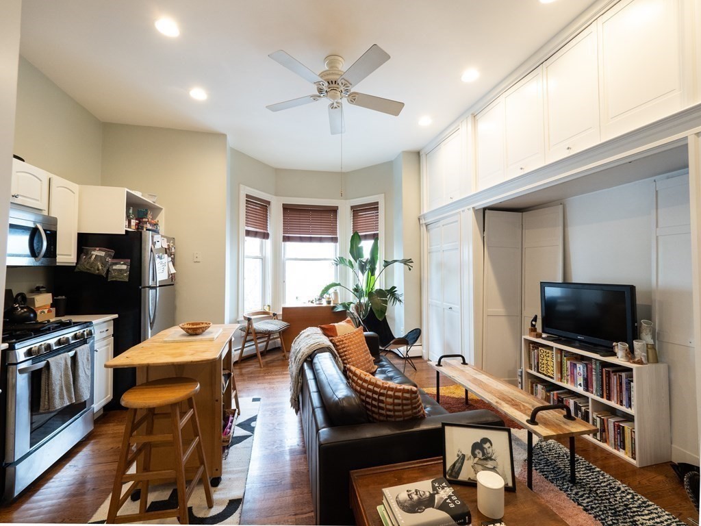 25 Fort Avenue, Unit 2 Boston, MA 02119 - Photo 3 of 12 a living room with furniture and a flat screen tv