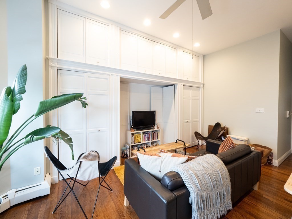 25 Fort Avenue, Unit 2 Boston, MA 02119 - Photo 4 of 12 a living room with furniture and a flat screen tv