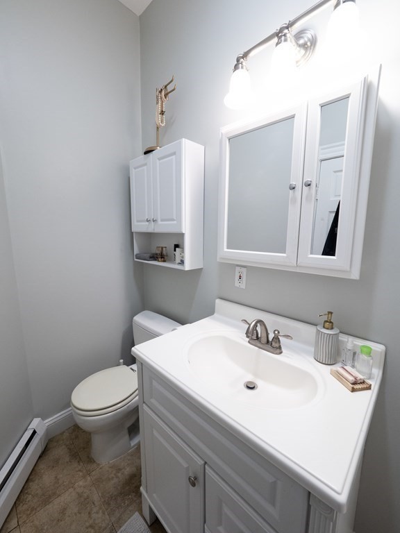 25 Fort Avenue, Unit 2 Boston, MA 02119 - Photo 6 of 12 a bathroom with a sink a toilet and mirror