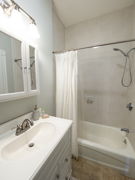 25 Fort Avenue, Unit 2 Boston, MA 02119 - Photo 7 of 12 a bathroom with a sink and a bathtub