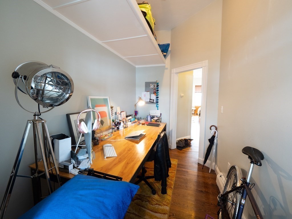 25 Fort Avenue, Unit 2 Boston, MA 02119 - Photo 9 of 12 a view of a room with furniture and wooden floor