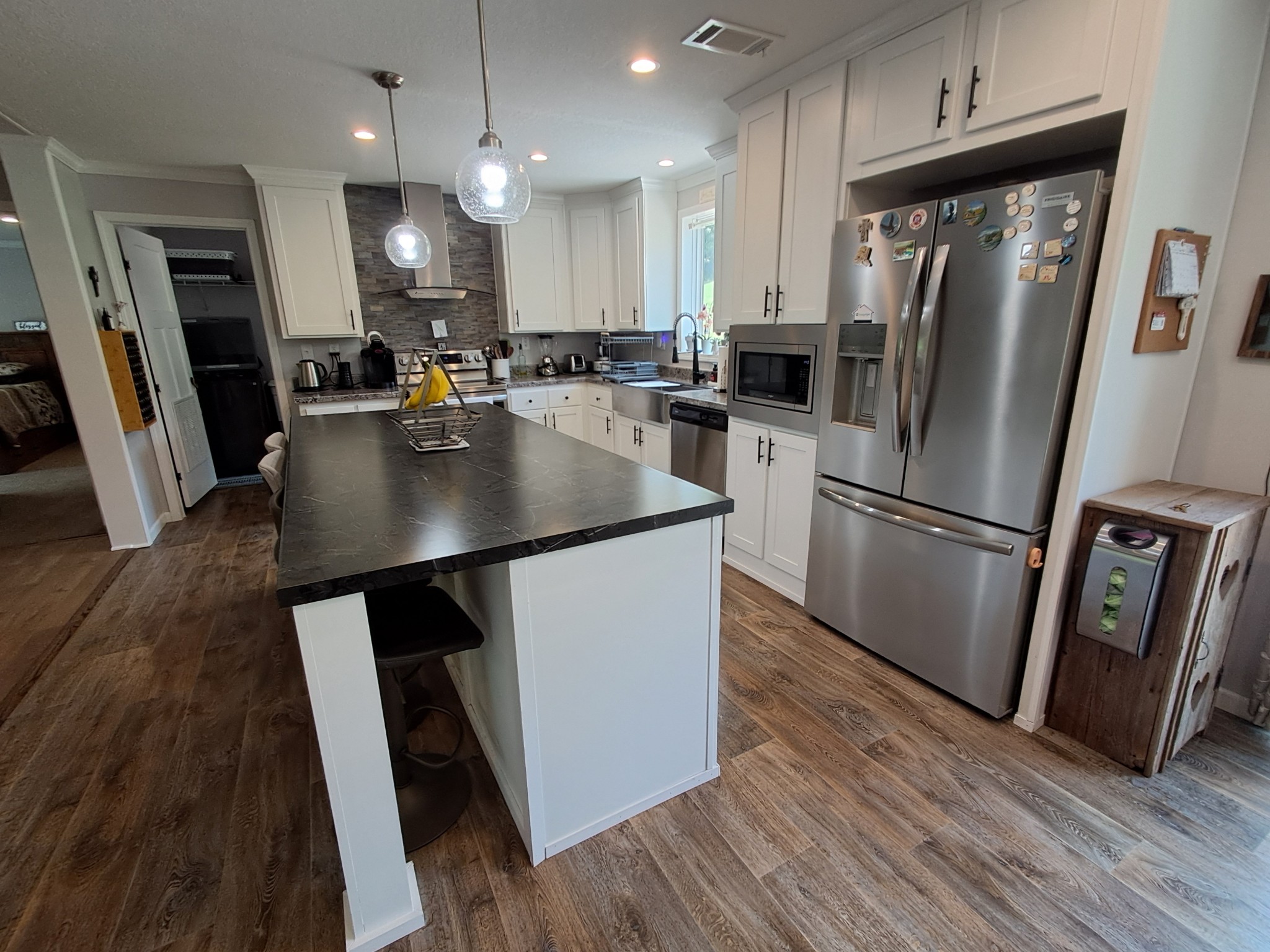 5525 Wiley Hollow Road Culleoka, TN 38451 - Photo 31 of 64 a kitchen with stainless steel appliances a refrigerator a sink a stove a microwave and wooden floor