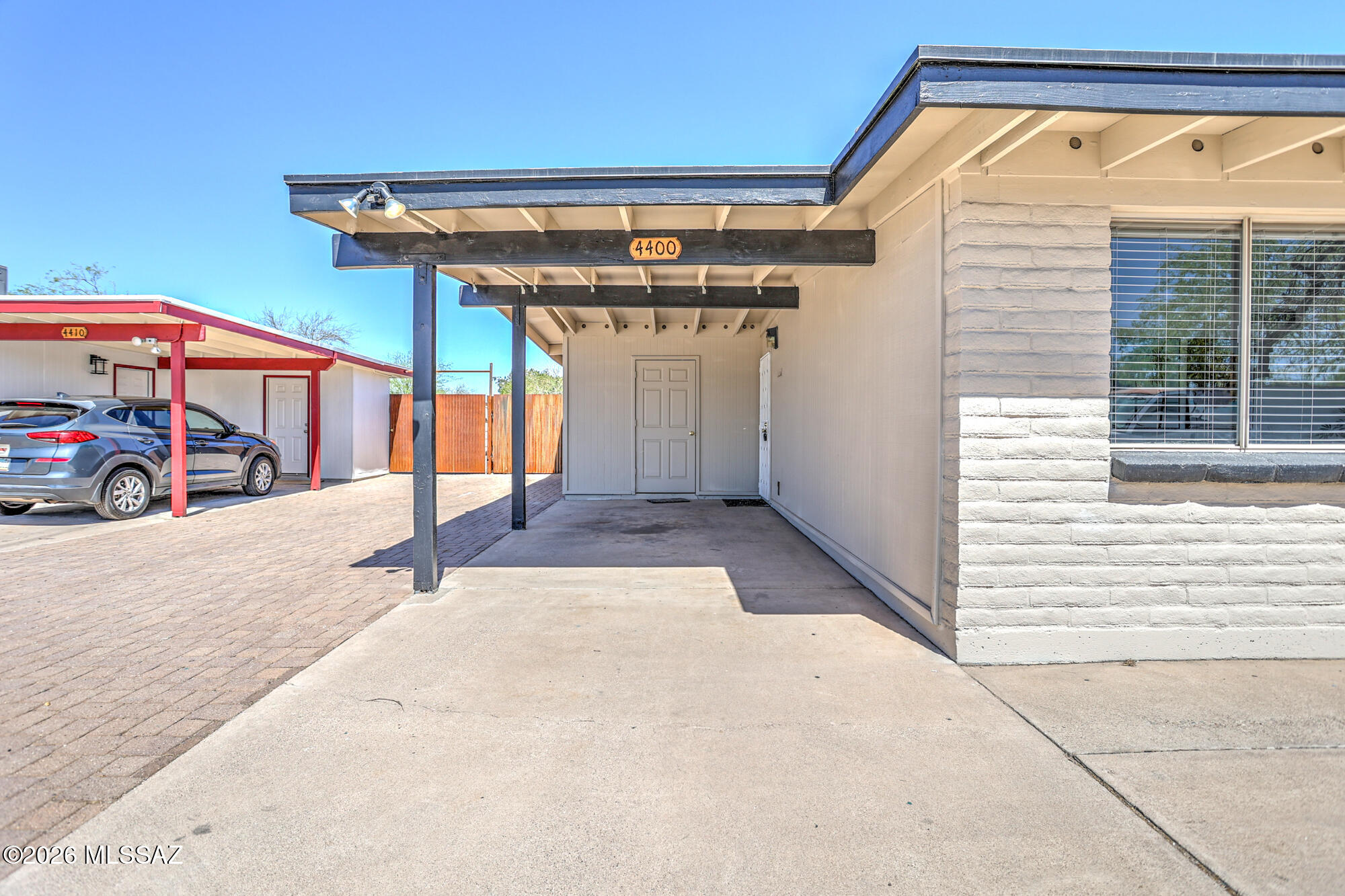 4400 West Ina Road Tucson, AZ 85741 - Photo 12 of 43 a view of a porch with a table and chairs under an umbrella