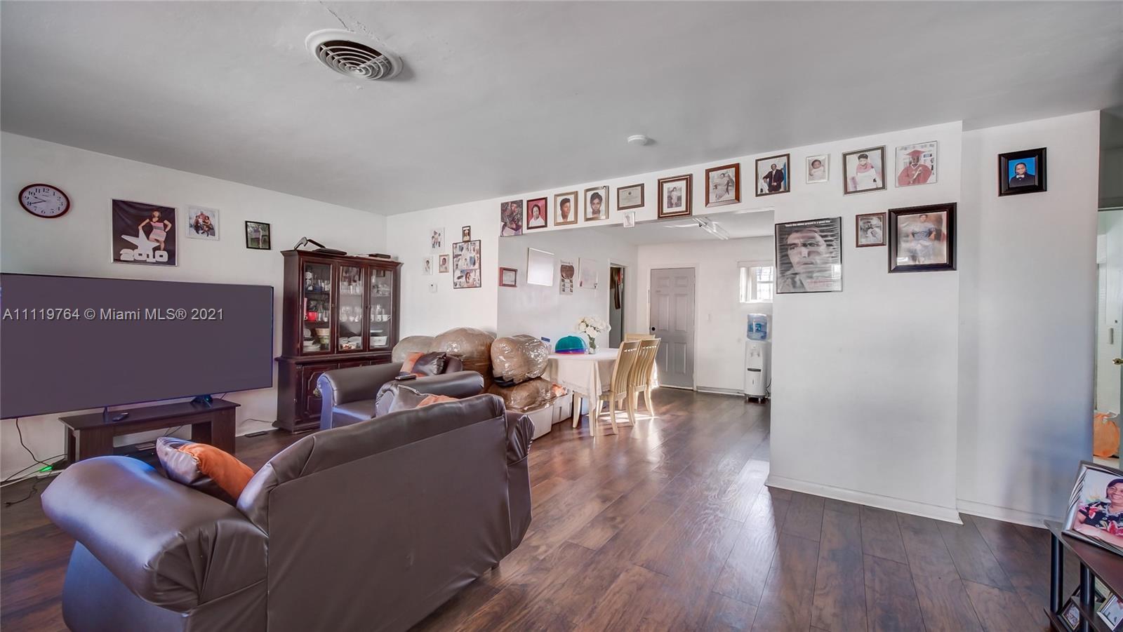 285 Northwest 97th Street Miami, FL 33150 - Photo 14 of 28 a living room with furniture and a wooden floor