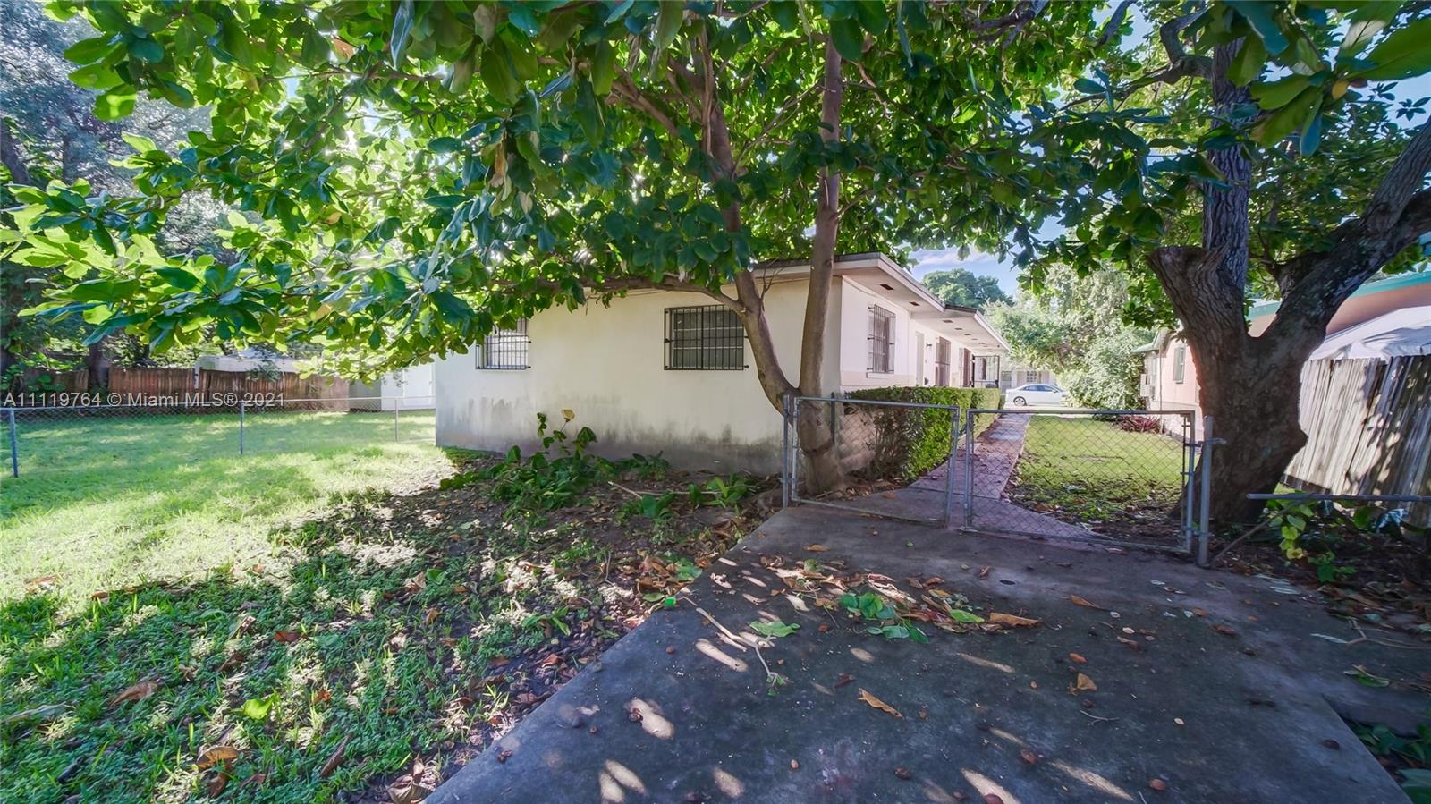 285 Northwest 97th Street Miami, FL 33150 - Photo 22 of 28 a backyard of a house with lots of green space