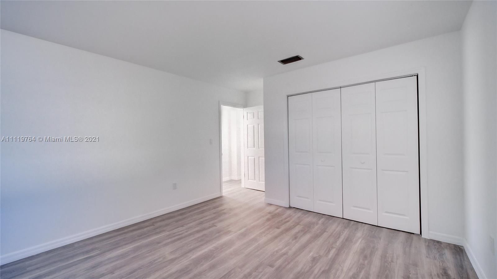 285 Northwest 97th Street Miami, FL 33150 - Photo 4 of 28 a view of an empty room and wooden floor
