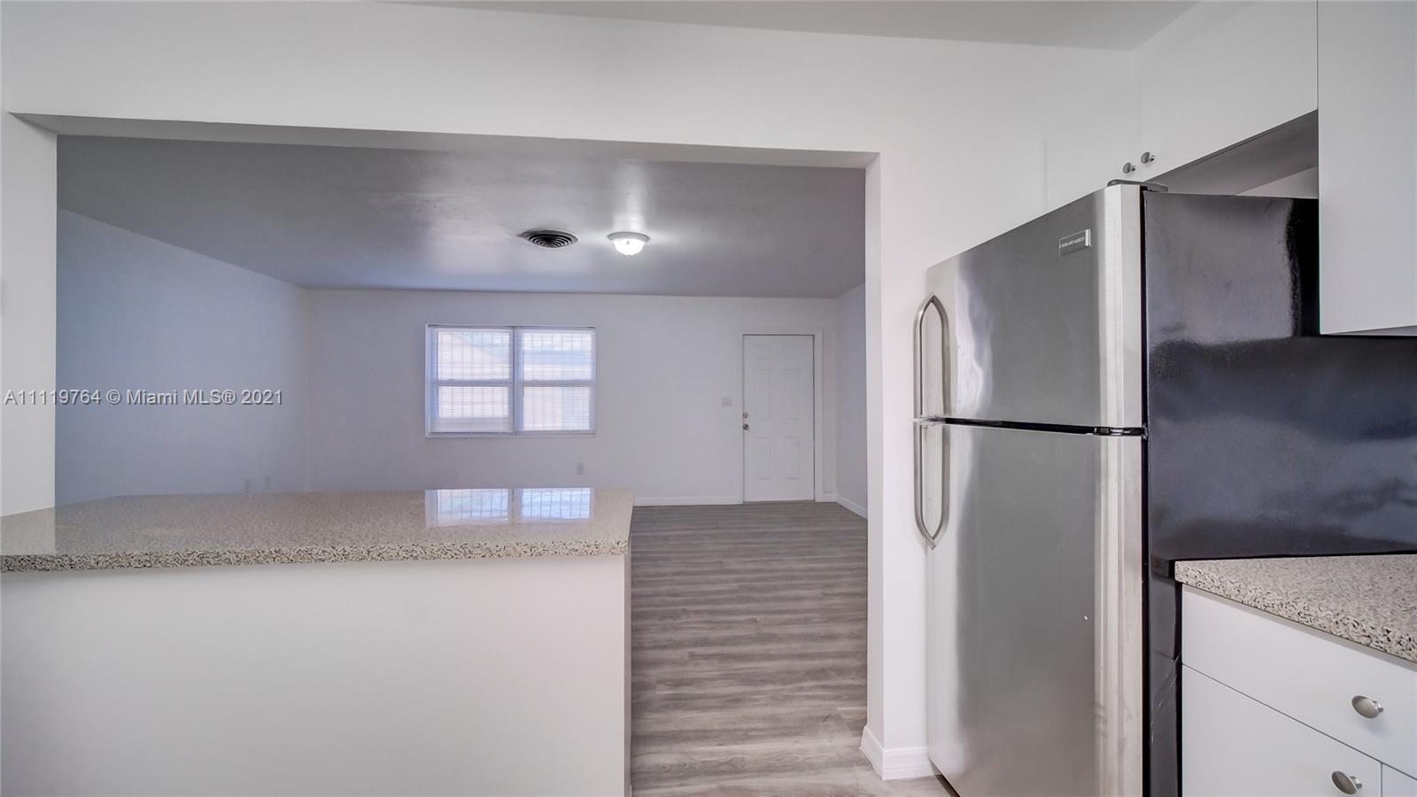 285 Northwest 97th Street Miami, FL 33150 - Photo 7 of 28 a view of kitchen with a refrigerator cabinet and a window