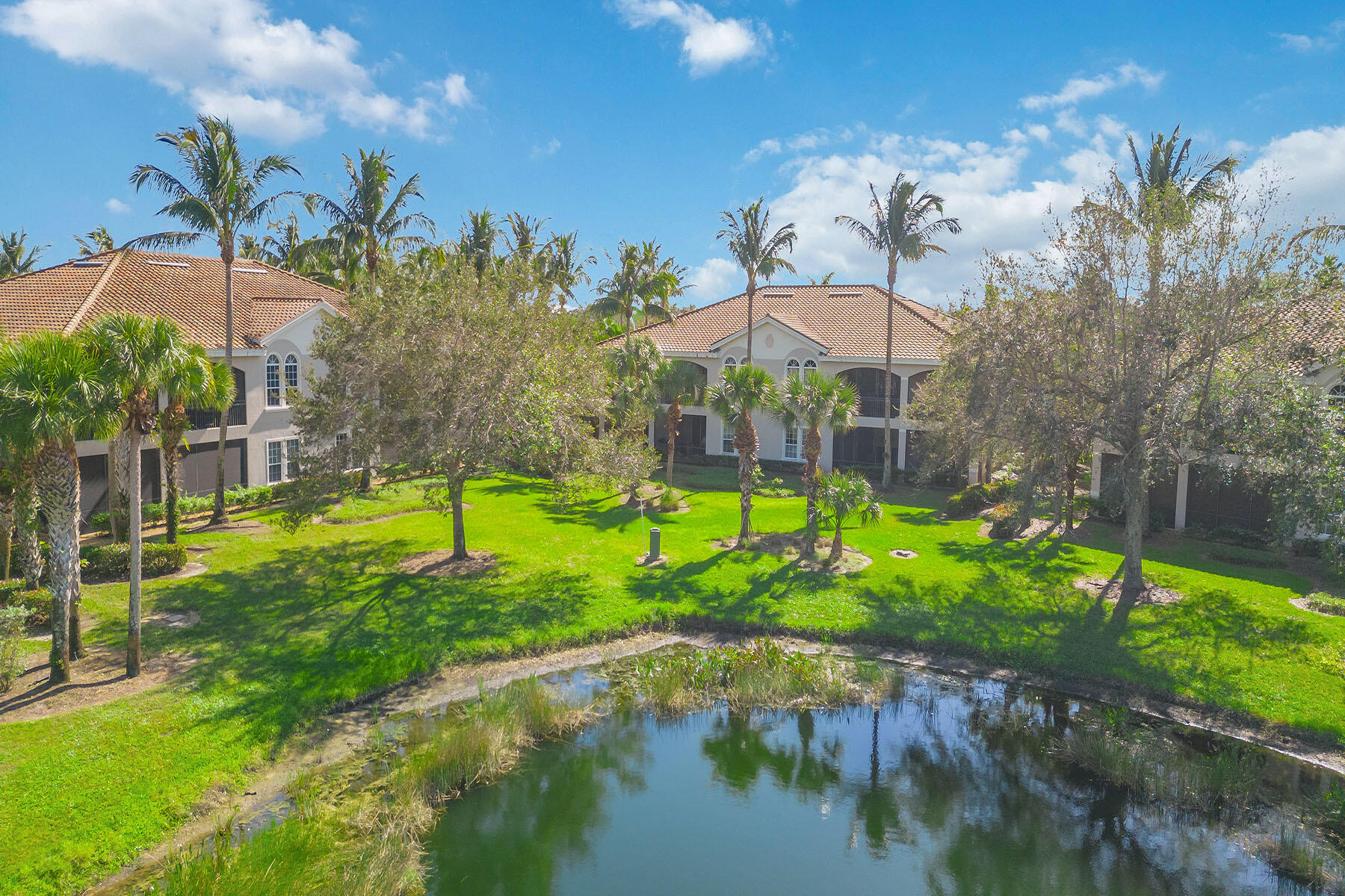 3189 Aviamar Circle, Unit 202 Naples, FL 34114 - Photo 28 of 50 a view of a garden with a lake