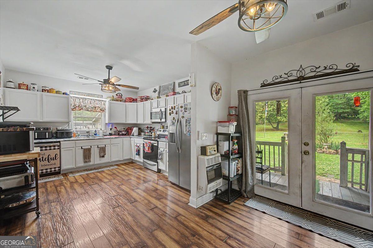 483 Coal Road Northwest Resaca, GA 30735 - Photo 24 of 56 a kitchen with stainless steel appliances a stove top oven and a refrigerator