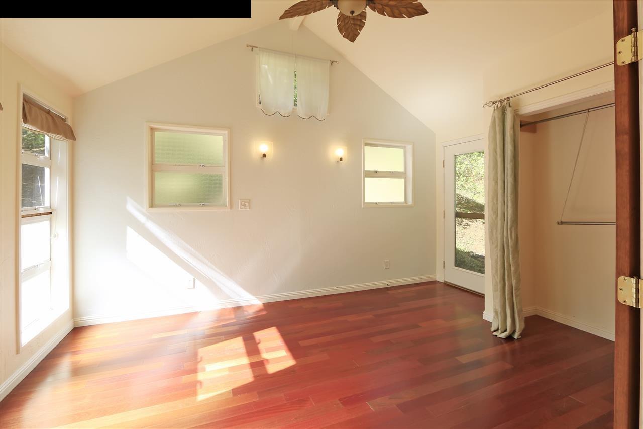 11 Kane Place Haiku, HI 96708 - Photo 17 of 30 a view of a hallway with wooden floor and a bathroom