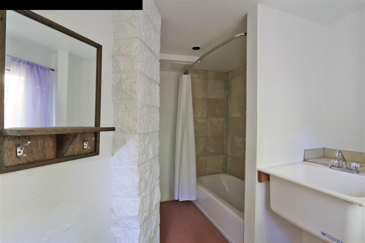 11 Kane Place Haiku, HI 96708 - Photo 9 of 30 a bathroom with a tub sink and mirror