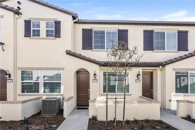 a view of a white house with large windows