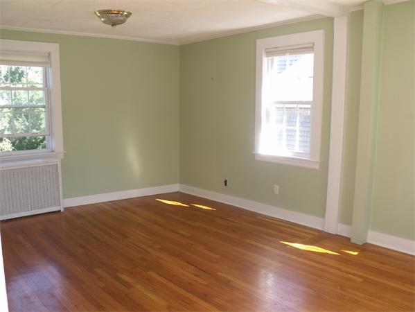 307 Harvard Road Bolton, MA 01740 - Photo 12 of 26 an empty room with wooden floor and windows