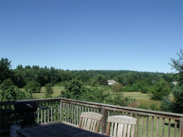 307 Harvard Road Bolton, MA 01740 - Photo 22 of 26 a view of a wooden deck with a yard