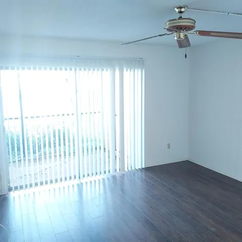a view of a livingroom with wooden floor and a window