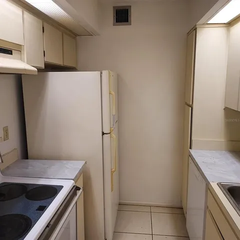 a kitchen with a refrigerator and a sink