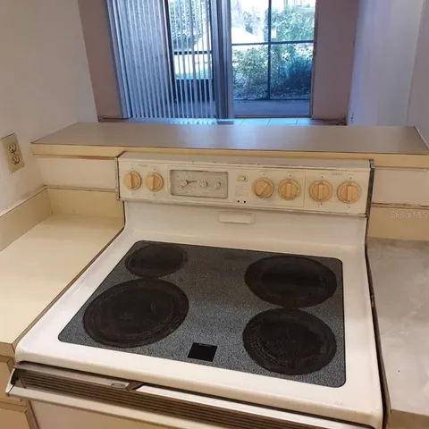 a view of a kitchen with a sink and a refrigerator