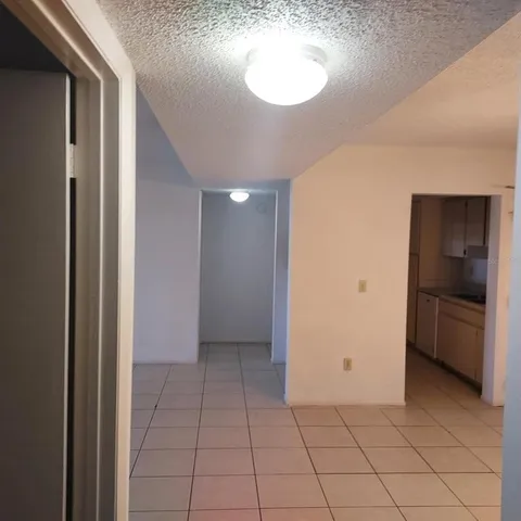a view of a room with wooden floor and a window