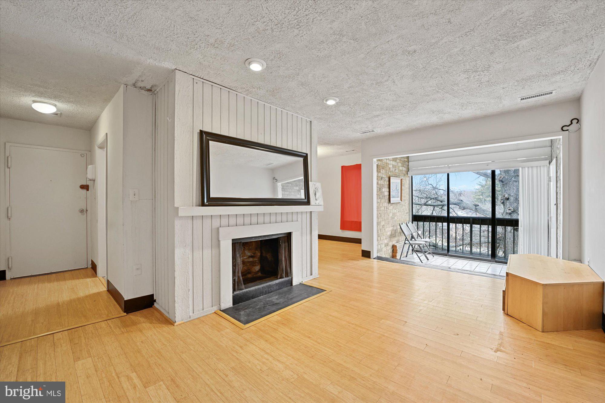 10578 Cross Fox Lane, Unit E2 Columbia, MD 21044 - Photo 12 of 28 a view of an empty room with a fireplace and a window