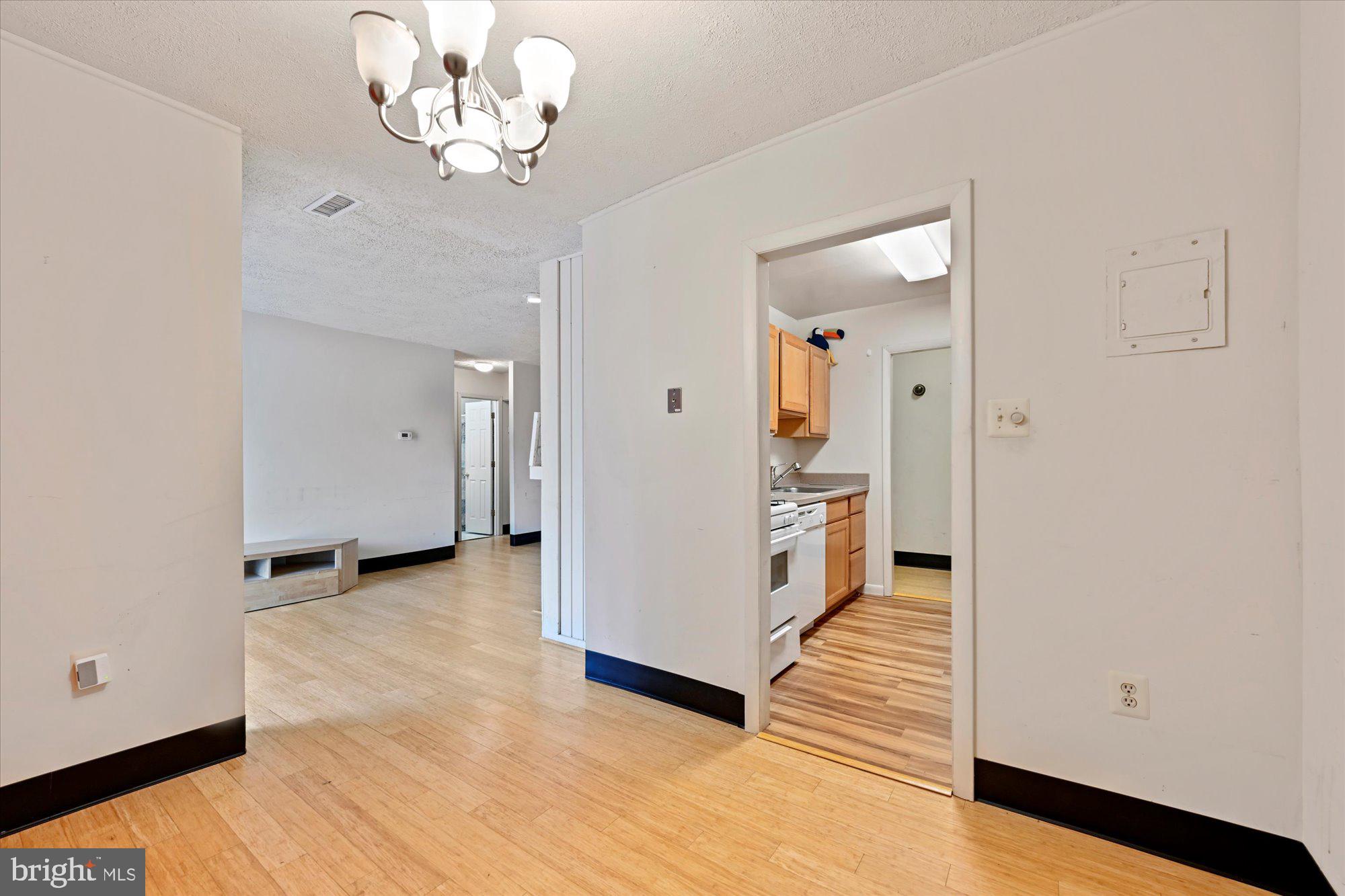 10578 Cross Fox Lane, Unit E2 Columbia, MD 21044 - Photo 15 of 28 a view of a hallway with wooden floor and a kitchen