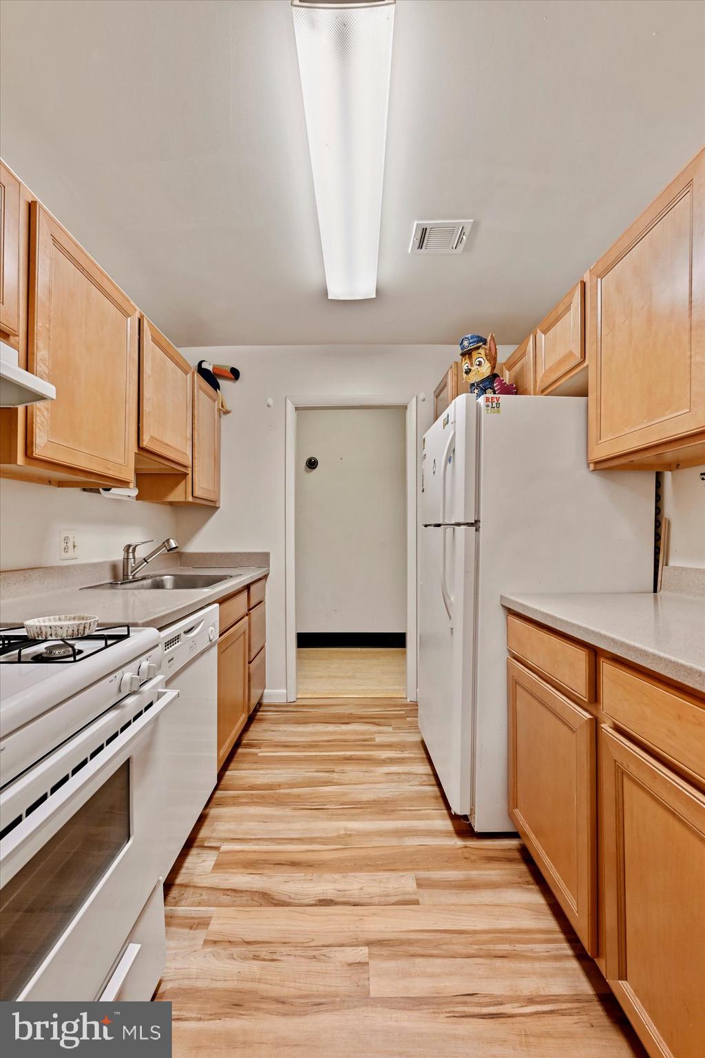 10578 Cross Fox Lane, Unit E2 Columbia, MD 21044 - Photo 16 of 28 a kitchen with stainless steel appliances granite countertop a sink stove and refrigerator