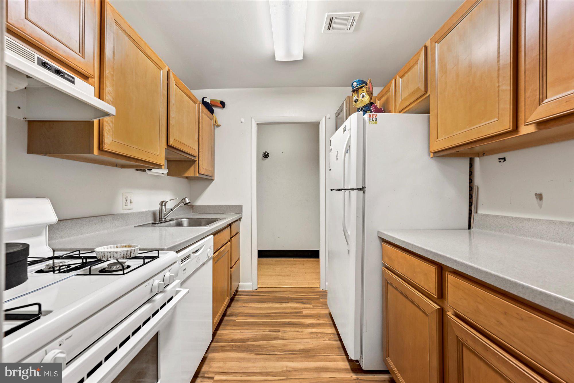 10578 Cross Fox Lane, Unit E2 Columbia, MD 21044 - Photo 17 of 28 a kitchen with stainless steel appliances granite countertop a stove and a refrigerator