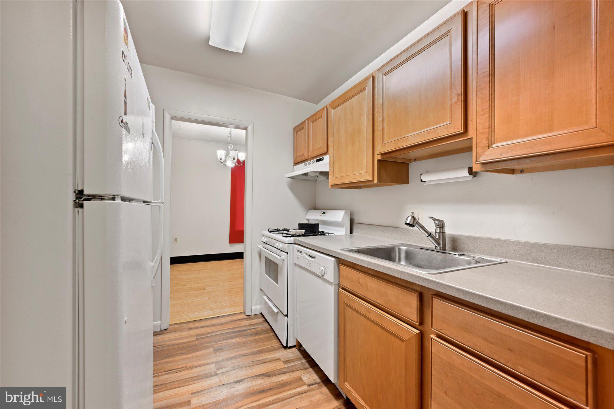 10578 Cross Fox Lane, Unit E2 Columbia, MD 21044 - Photo 18 of 28 a kitchen with stainless steel appliances granite countertop a sink stove and cabinets
