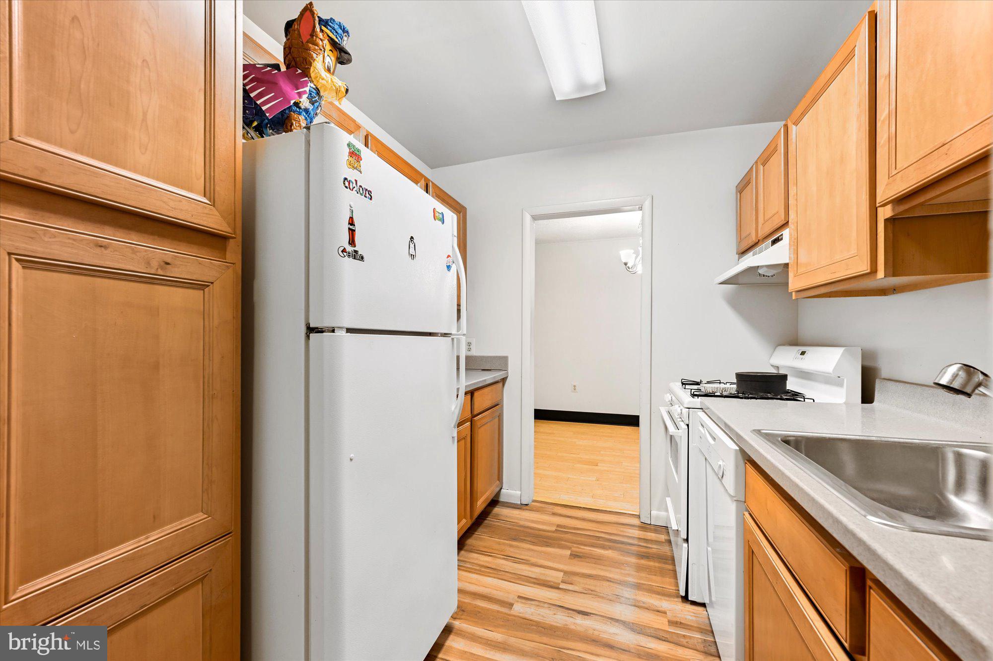 10578 Cross Fox Lane, Unit E2 Columbia, MD 21044 - Photo 19 of 28 a kitchen with stainless steel appliances granite countertop a refrigerator and a sink