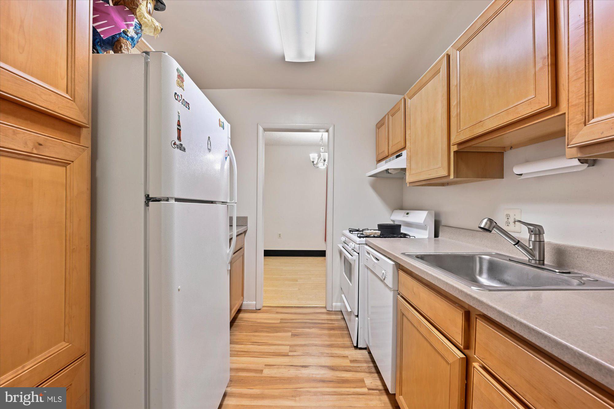 10578 Cross Fox Lane, Unit E2 Columbia, MD 21044 - Photo 20 of 28 a kitchen with a sink a refrigerator and cabinets