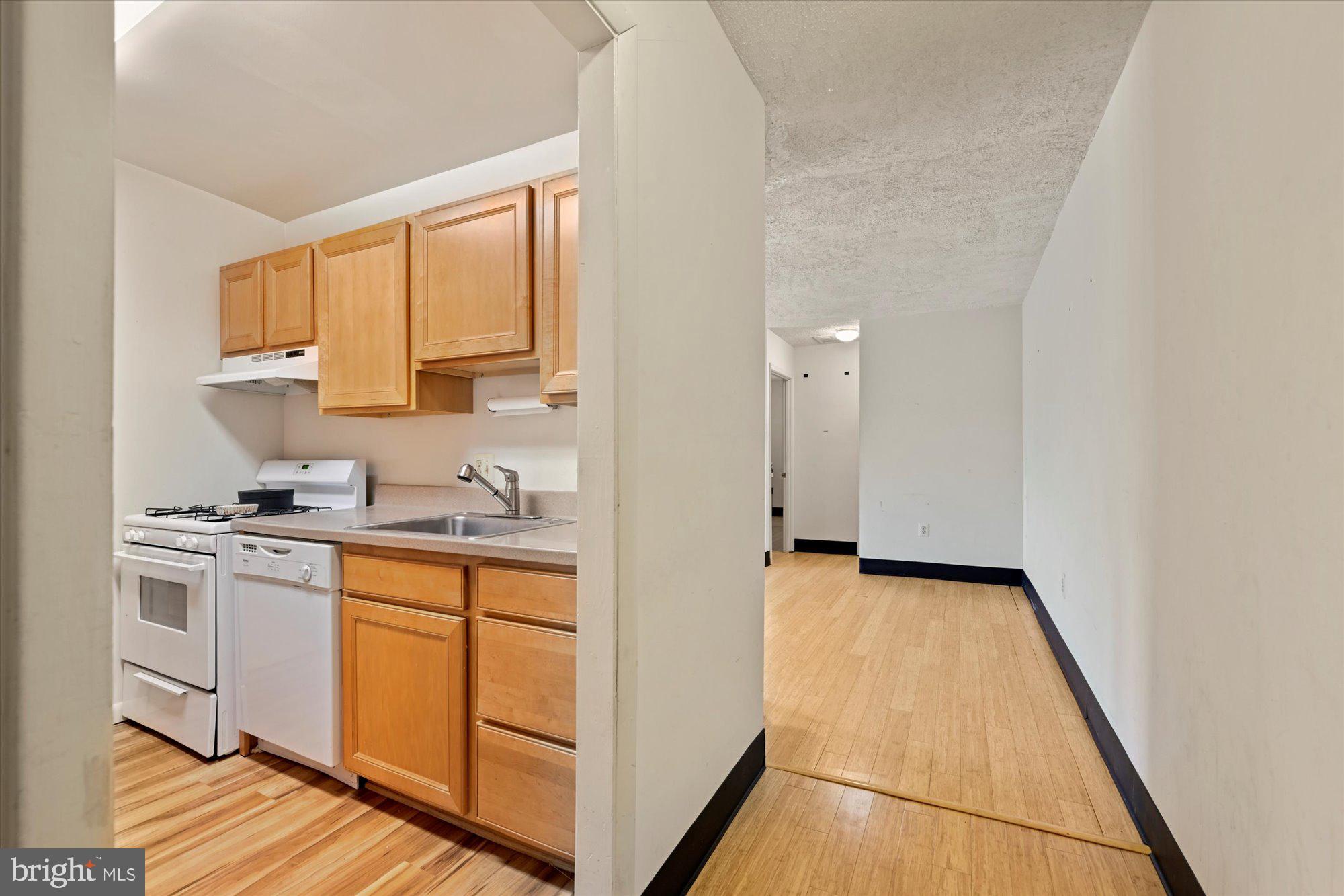10578 Cross Fox Lane, Unit E2 Columbia, MD 21044 - Photo 21 of 28 a kitchen with stainless steel appliances granite countertop a stove a sink and a refrigerator