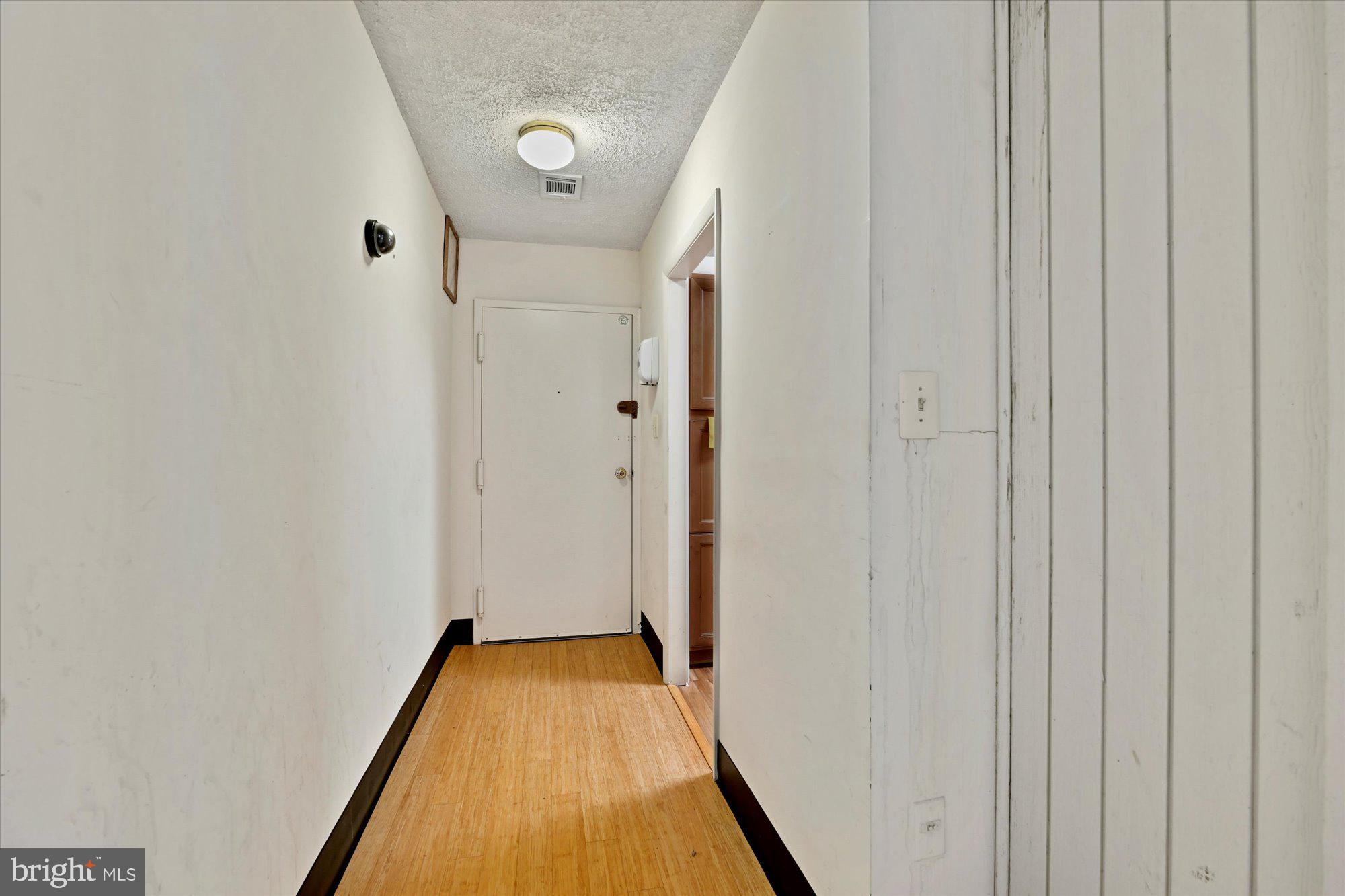 10578 Cross Fox Lane, Unit E2 Columbia, MD 21044 - Photo 22 of 28 a view of a hallway with wooden floor