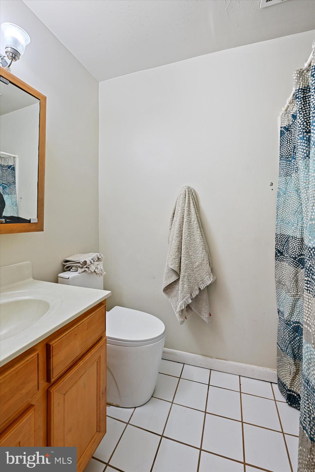 10578 Cross Fox Lane, Unit E2 Columbia, MD 21044 - Photo 8 of 28 a bathroom with a sink toilet and mirror