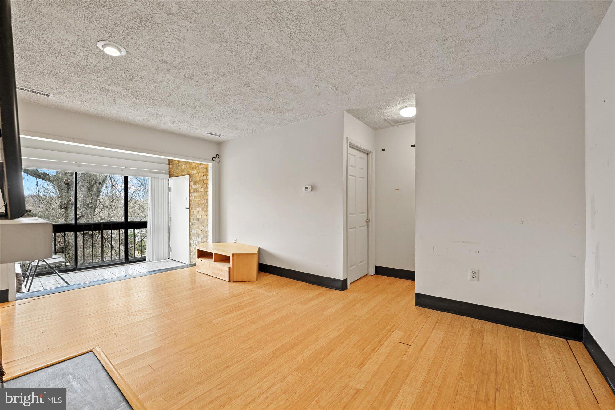 10578 Cross Fox Lane, Unit E2 Columbia, MD 21044 - Photo 10 of 28 a view of an empty room with glass door