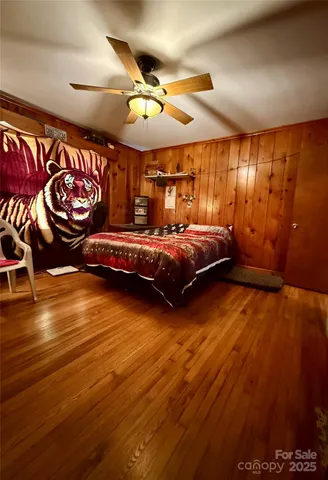 a bedroom with furniture and wooden floor