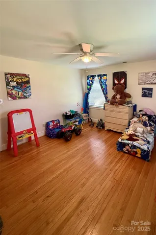 a bedroom with furniture and a wooden floor