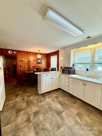a large white kitchen with a large window
