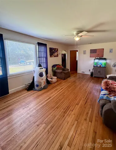 a bedroom with furniture and a wooden floor