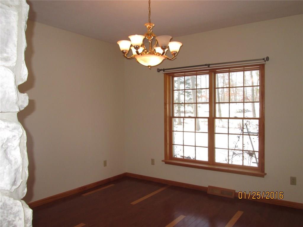335 Myoma Road Mars, PA 16046 - Photo 3 of 20 Dining Room features an impressive double-sided floor to ceiling stone fireplace dividing it from the Living Room