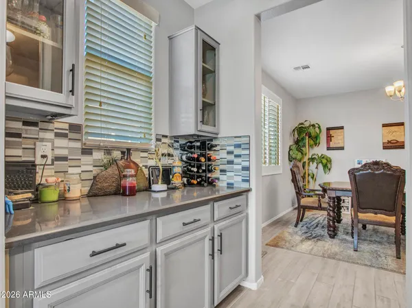 a view of a dining room with furniture a chandelier windows and wooden floor