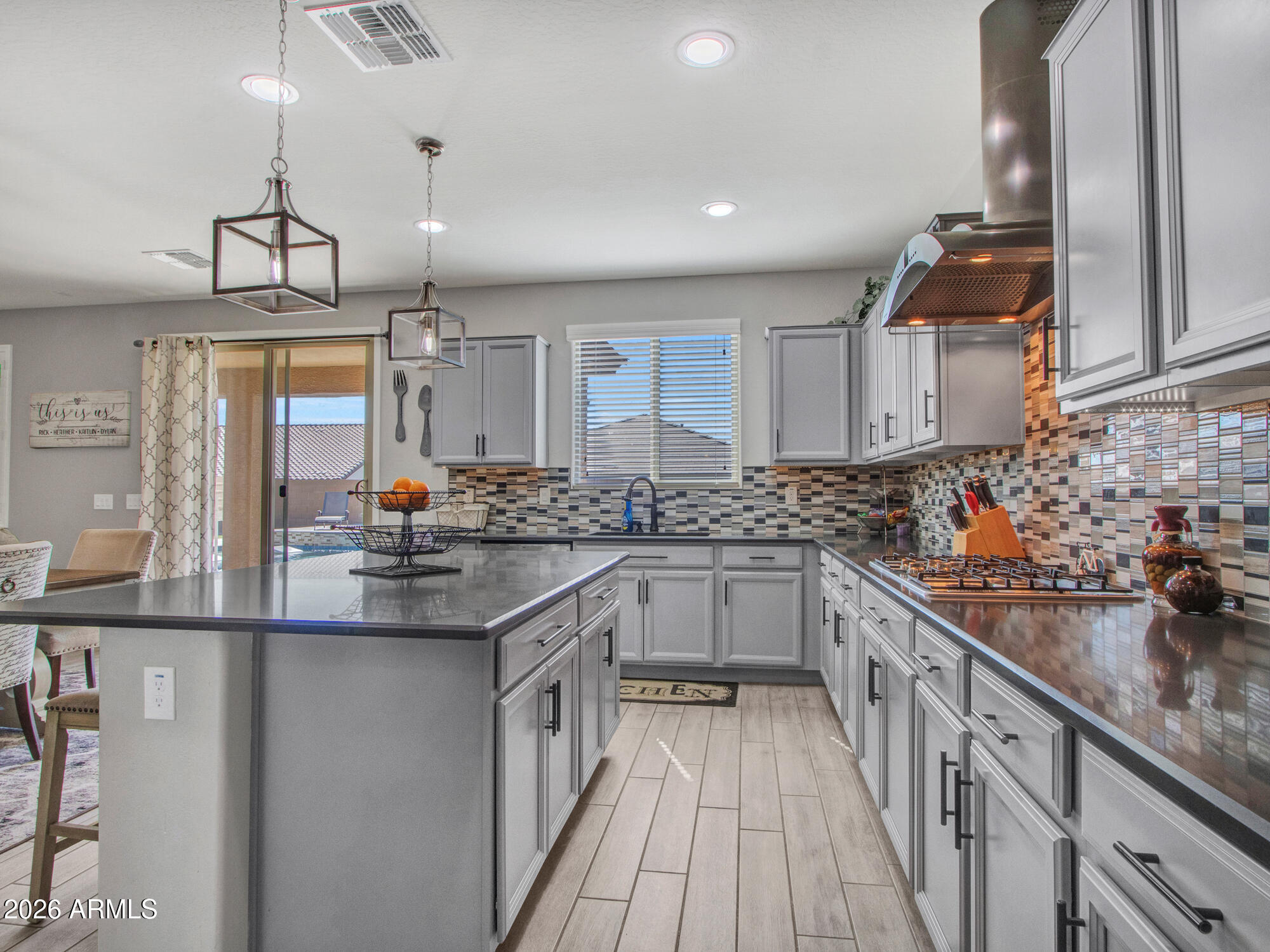 18971 West Clinton Street Surprise, AZ 85388 - Photo 17 of 91 a kitchen with stainless steel appliances granite countertop a sink and cabinets