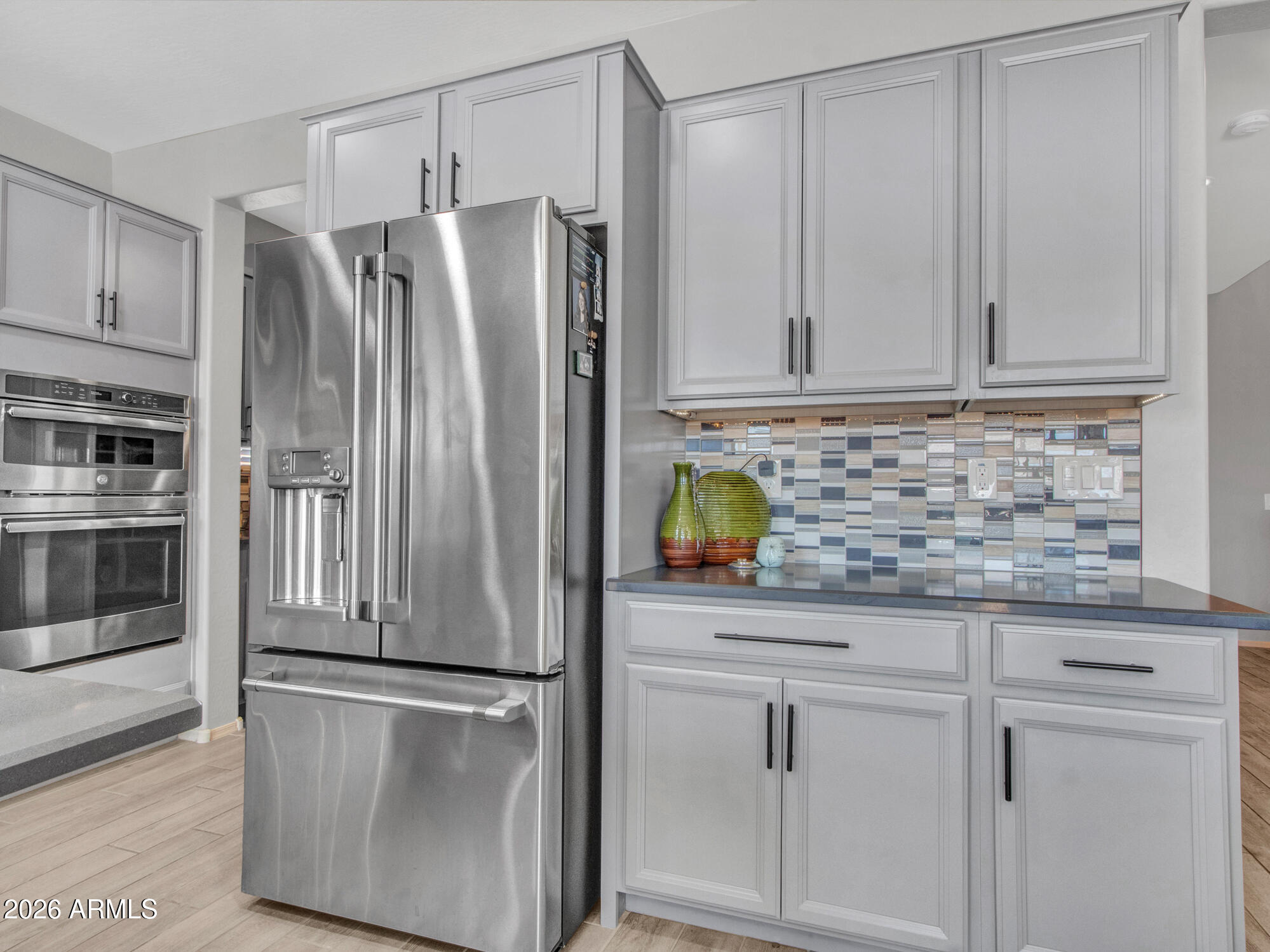 18971 West Clinton Street Surprise, AZ 85388 - Photo 18 of 91 a kitchen with stainless steel appliances granite countertop a refrigerator a stove and a sink with cabinets