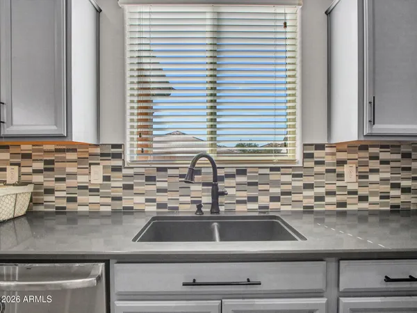 a living room with furniture and a ceiling fan