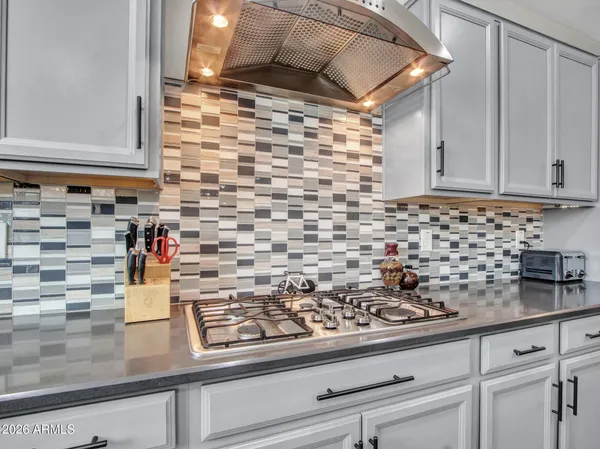 a spacious bedroom with a bed and a chandelier