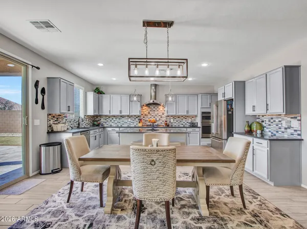 a spacious bedroom with a bed and a chandelier
