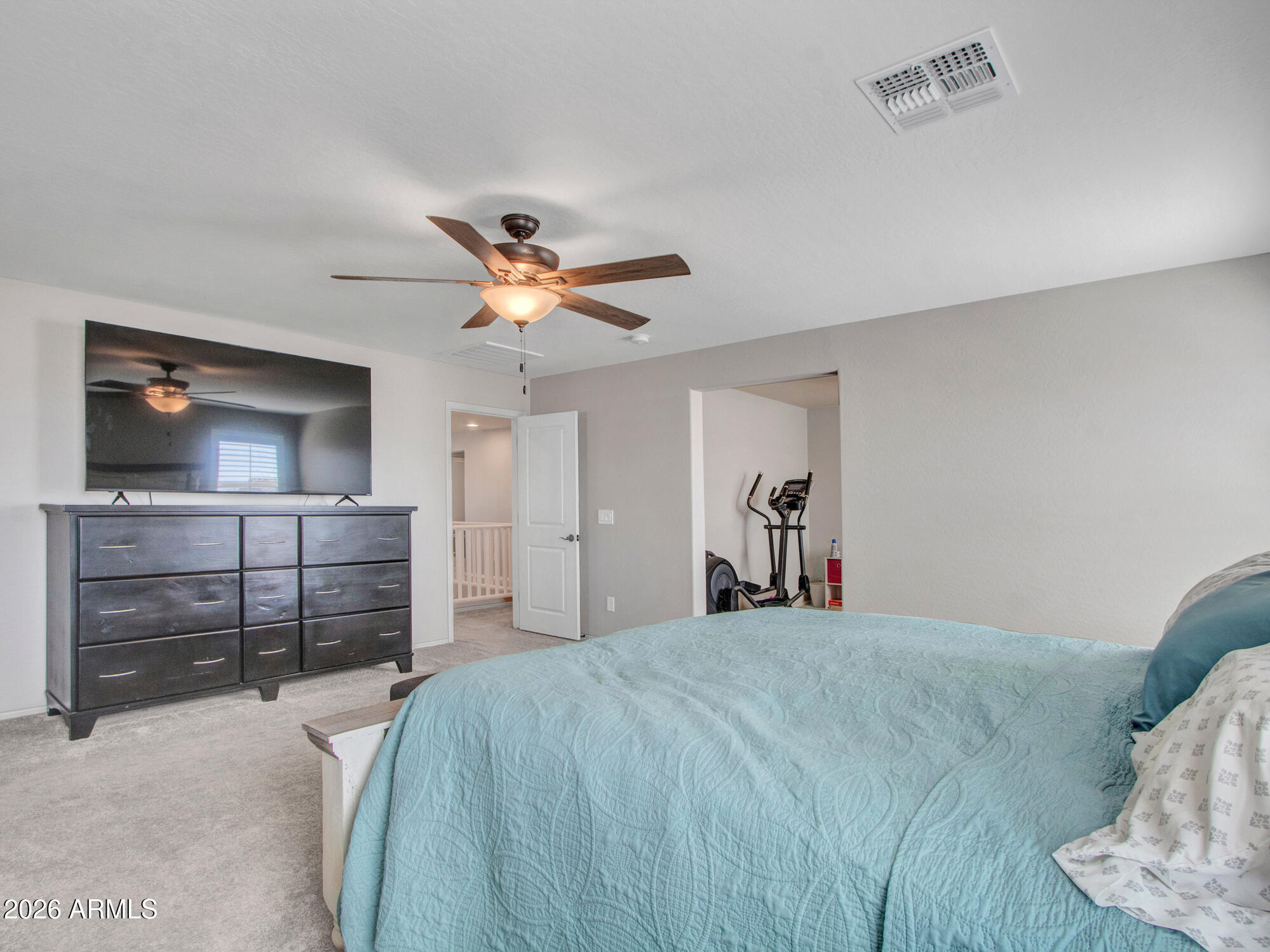 18971 West Clinton Street Surprise, AZ 85388 - Photo 44 of 91 a bedroom with a bed and a flat screen tv